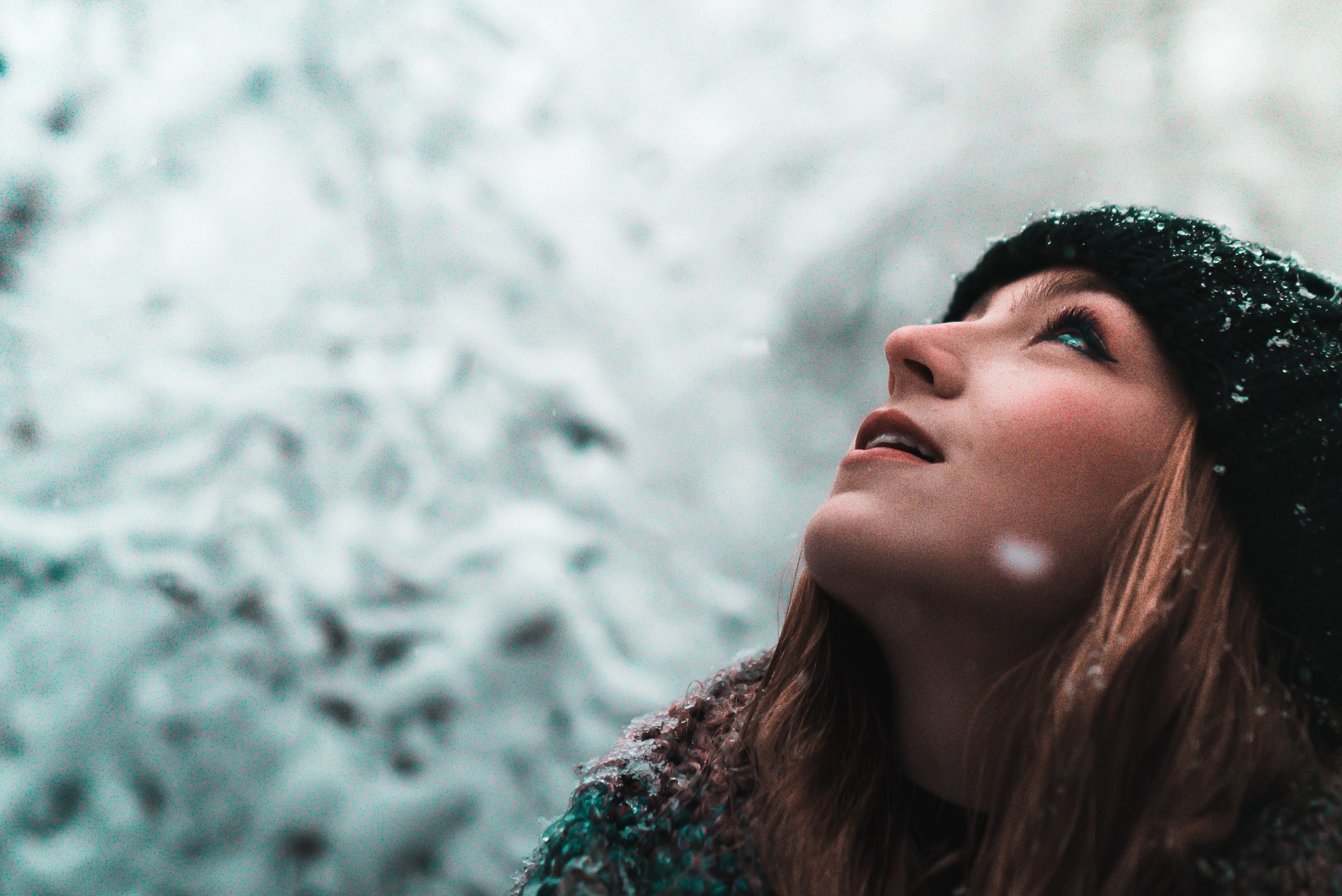 Woman gazing upward in snowy weather