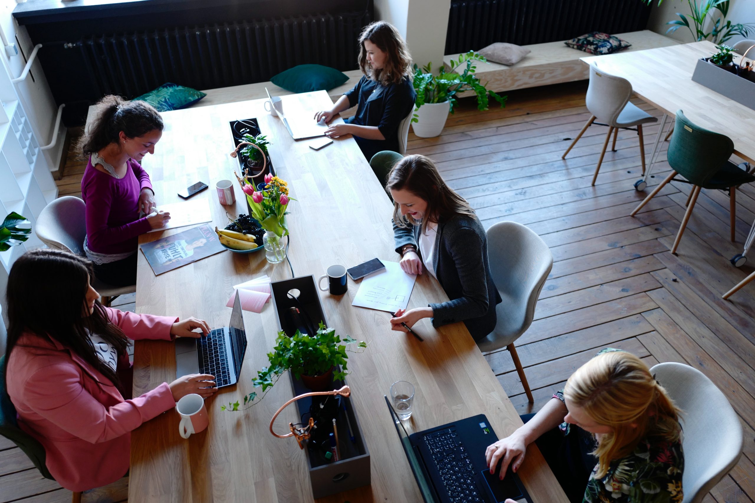 Office meeting with colleagues working around a table.
