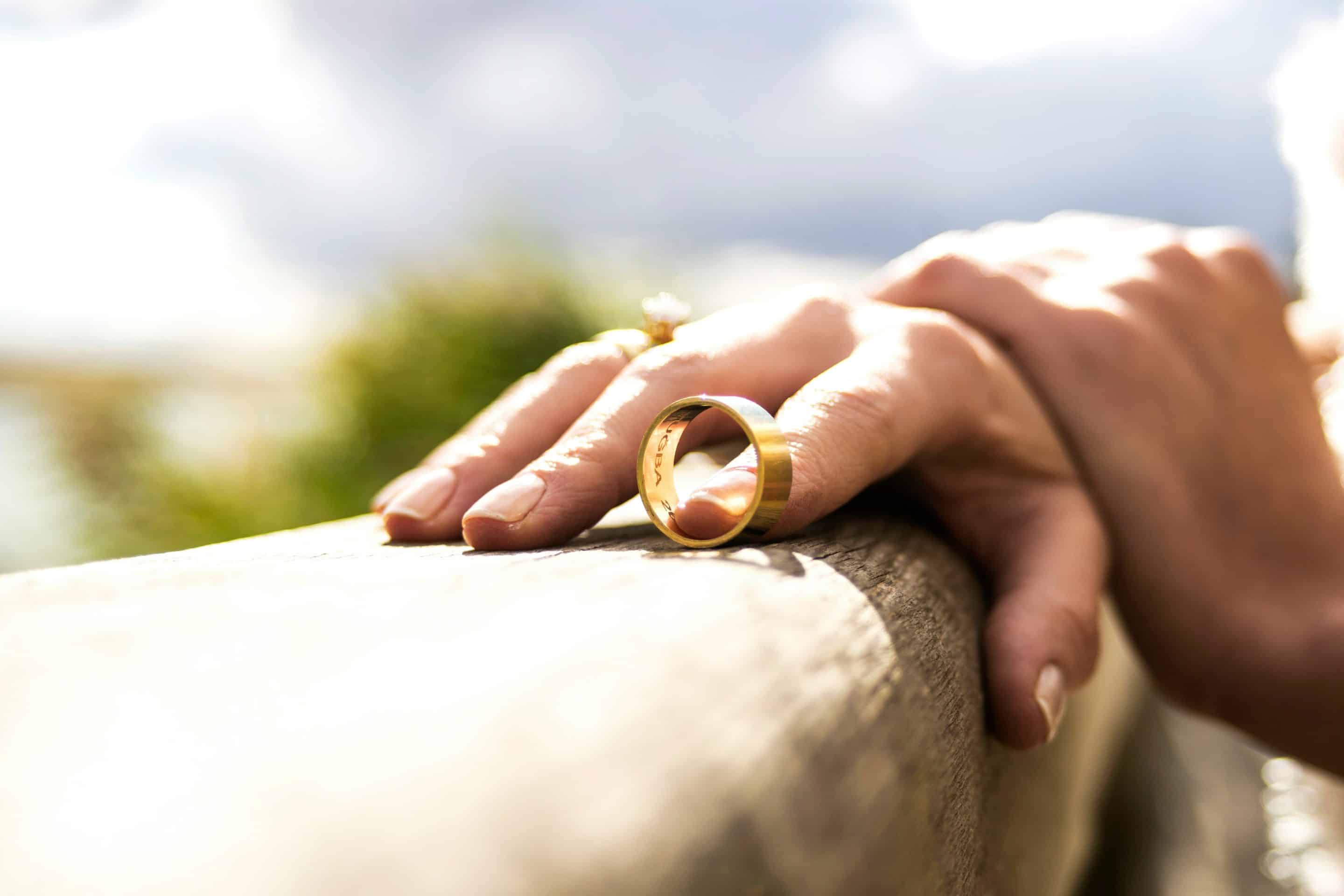 Hand with wedding ring on sunny day