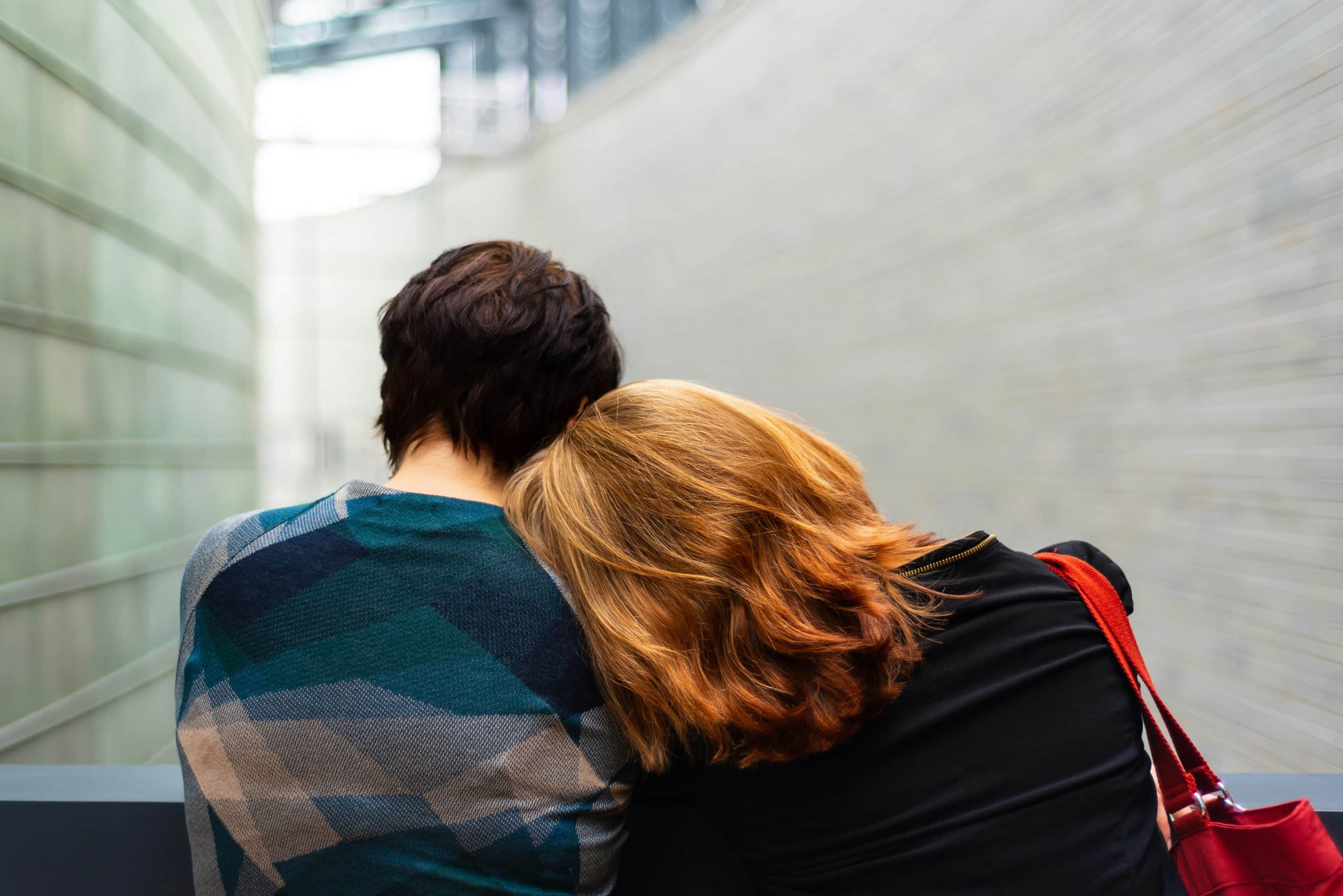 Two people embracing, showing affection.