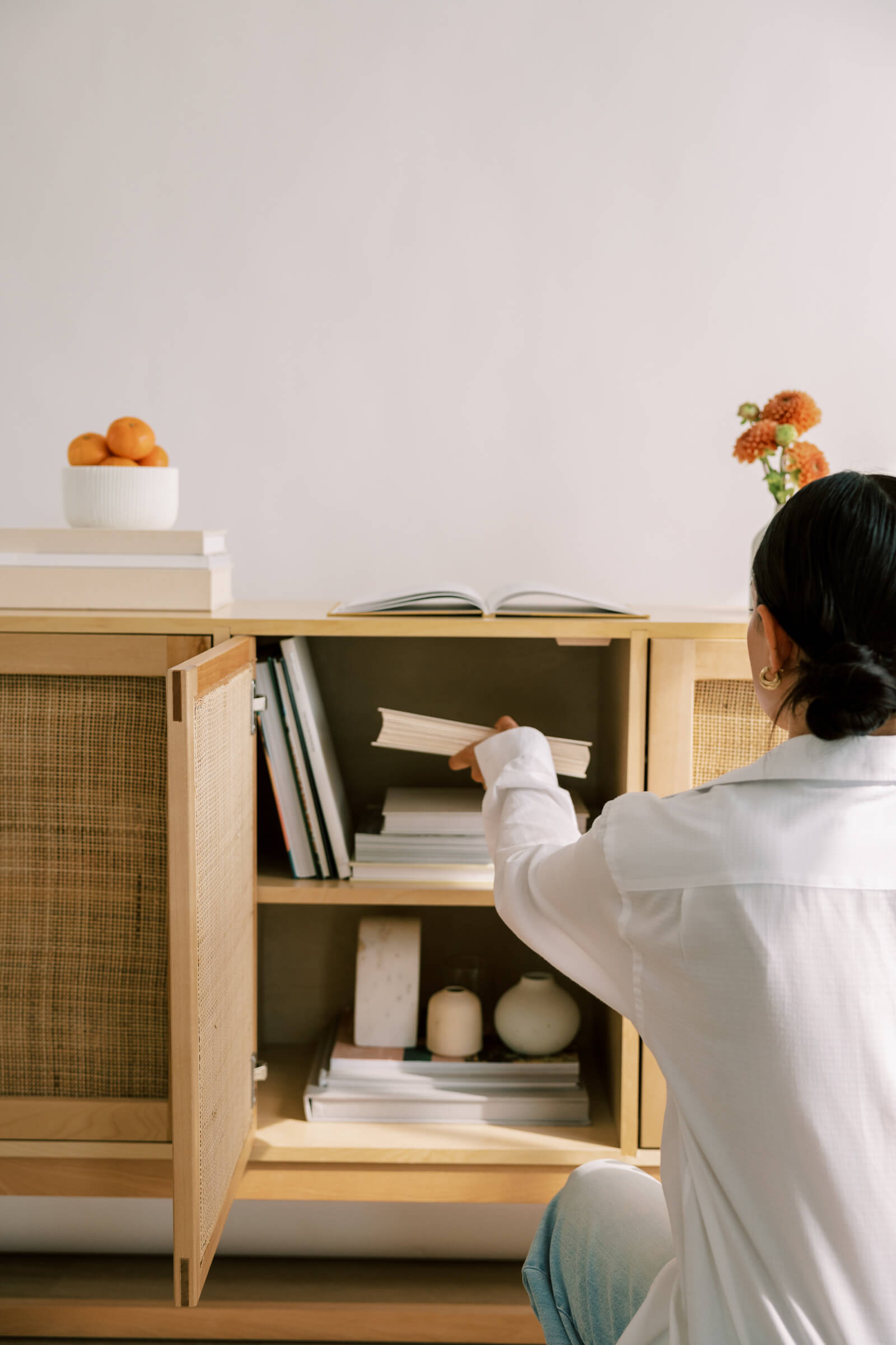 Woman putting away book on gaslighting in her St. George UT home